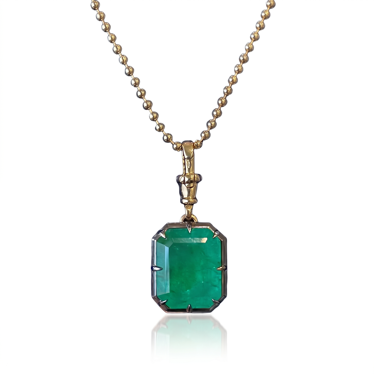 13.1 carat natural Zambian emerald pendant in 18K yellow gold and blackened platinum