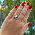 The Caroline ring: antique pear cut lab-grown diamond in a blackened collet on a yellow gold shank