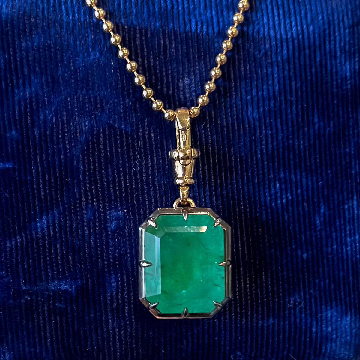 13.1 carat natural Zambian emerald pendant in 18K yellow gold and blackened platinum