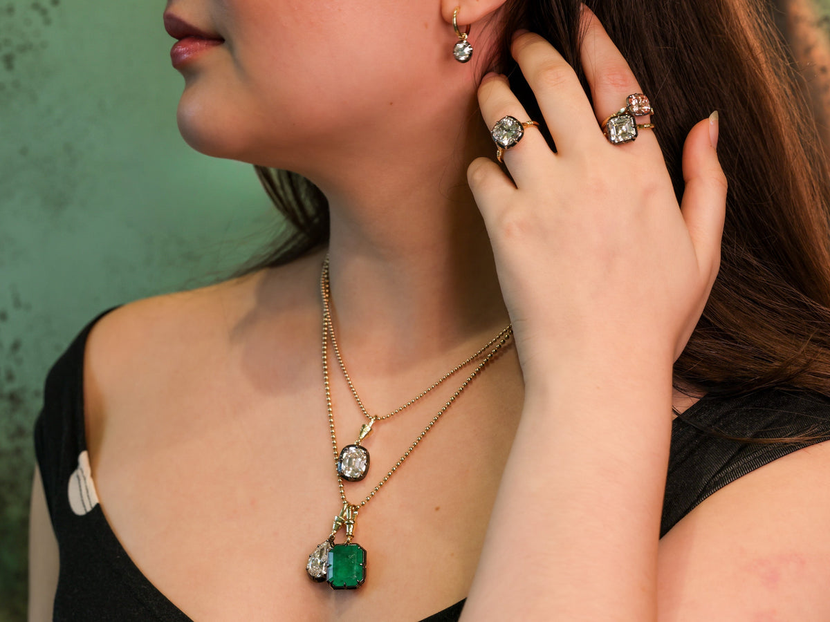 13.1 carat natural Zambian emerald pendant in 18K yellow gold and blackened platinum