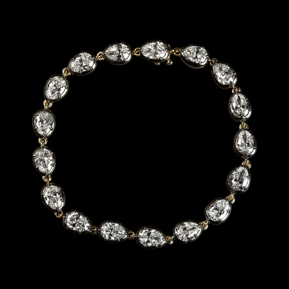 The Caroline Bracelet: collet-set antique pear cut lab-grown diamonds in blackened platinum over 18K yellow gold