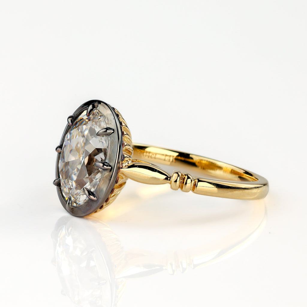 The Caroline ring: antique oval lab-grown diamond in a blackened collet on a yellow gold snake shank, view 4