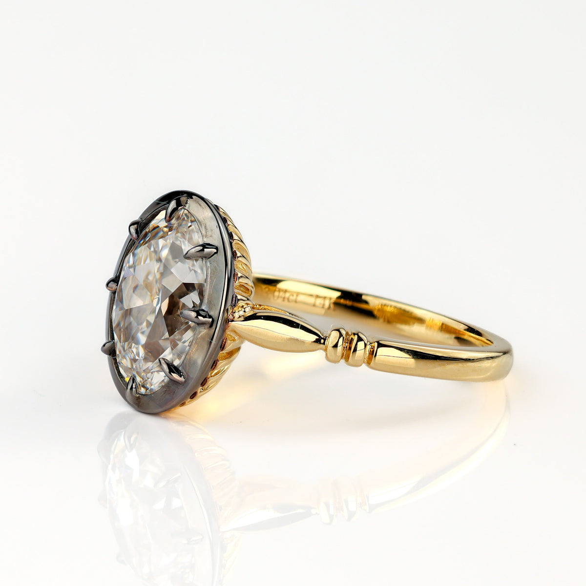 The Caroline ring: antique oval lab-grown diamond in a blackened collet on a yellow gold snake shank, view 4