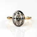 The Caroline ring: antique oval lab-grown diamond in a blackened collet on a yellow gold snake shank